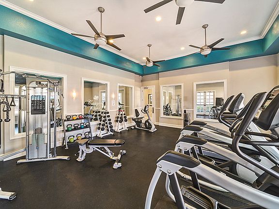 Fitness center with cardio and strength training equipment.