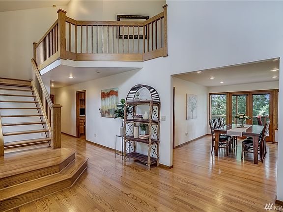 Incredible 2 story entry with solid oak open staircase. Formal dining with built-in buffet and French doors to the western facing deck.