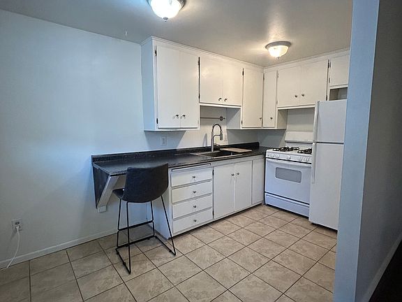 Front door to kitchen. New countertop and sink/faucet.