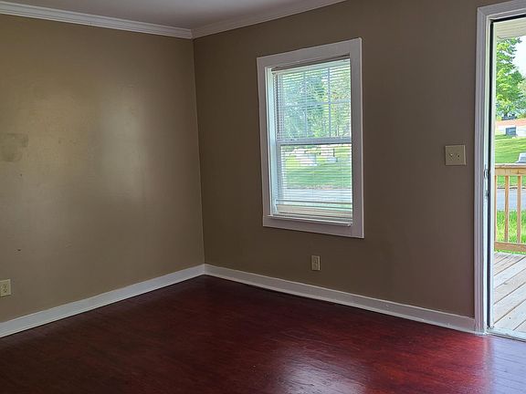 Living room with stained, natural hardwood floors.