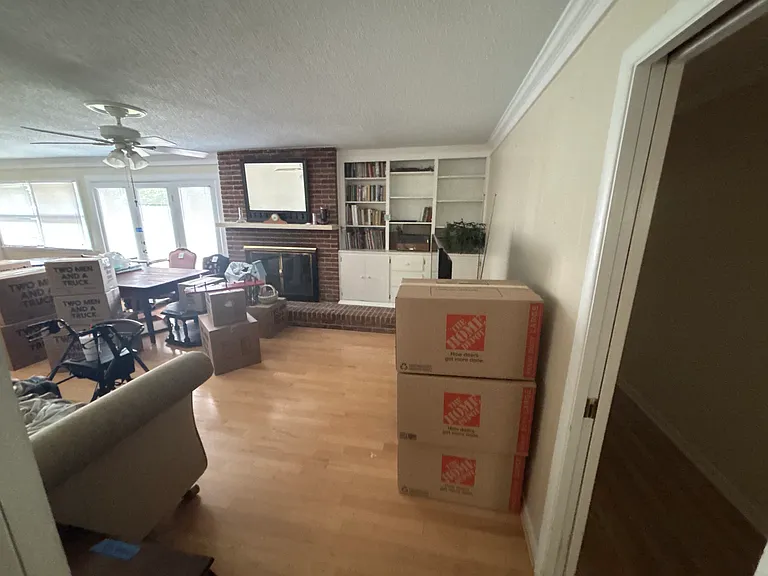 Family room, looking out towards back porch. Some remaining furnishings available to stay in home upon request.