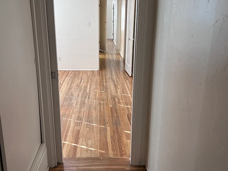 hallway connecting rooms to kitchen and bath areas