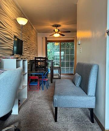 View from living room through dining room and out sliding door to deck