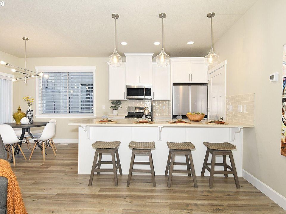 Kitchen opening up to outdoor deck and livingroom