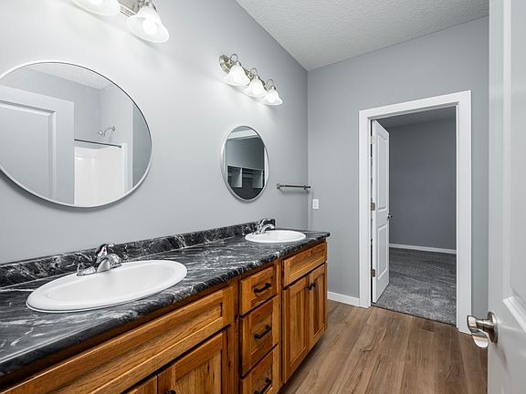 Master bedroom bathroom includes his/her sink with a walk in closet