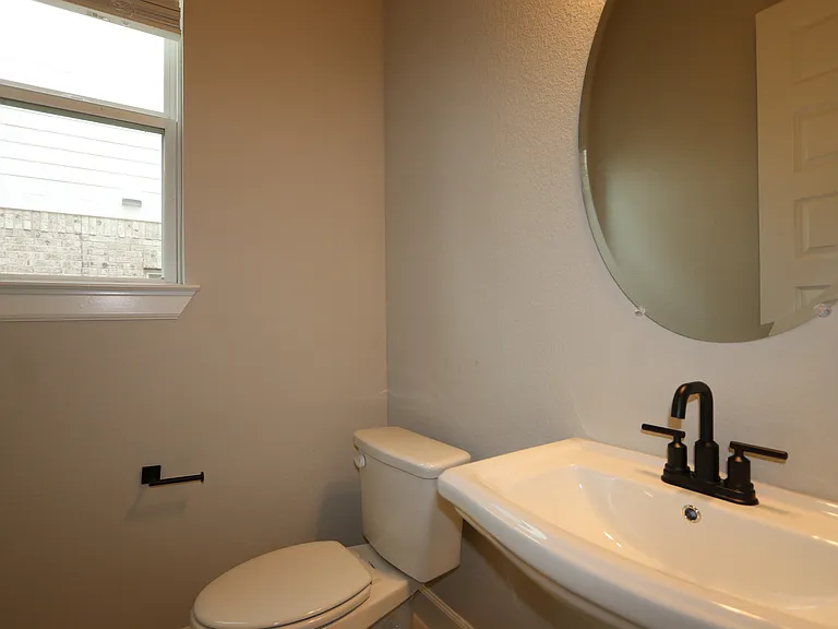 Convenient downstairs bathroom located near the front entry and home office_perfect for guests and everyday ease. Clean, accessible, and thoughtfully placed for comfort and functionality.
