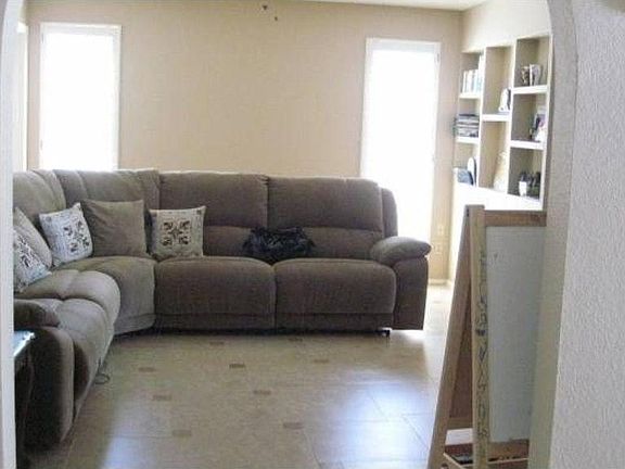 Family Room with wooden shutters, Designer flooring and pre-wired for surround sound.