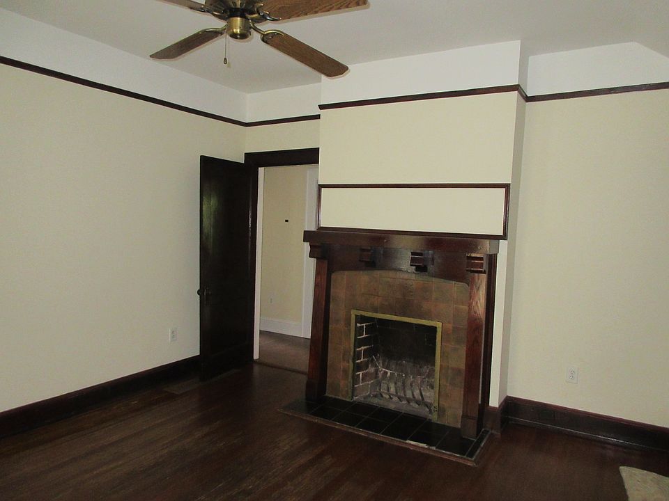Living Room with original mantle. Fresh paint throughout hom