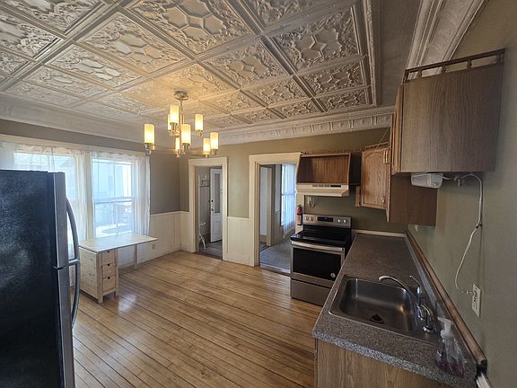 Bright eat-in kitchen with stainless steel appliances.