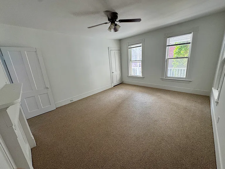 Primary bedroom with closet, looking onto Main Street.