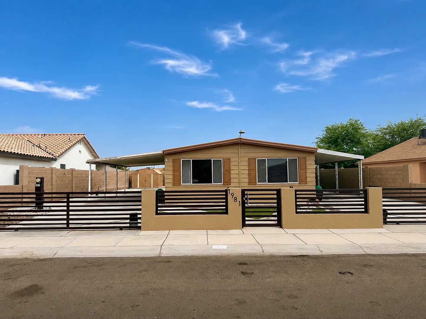 Fully Fenced 3 Bedroom Home with Covered Parking and Landscaped Property — Photo 1