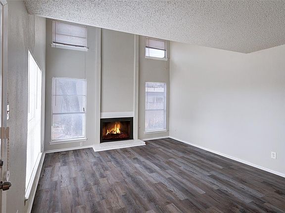 ANOTHER VIEW OF THE LIVING ROOM WITH WOOD BURNING FIREPLACE