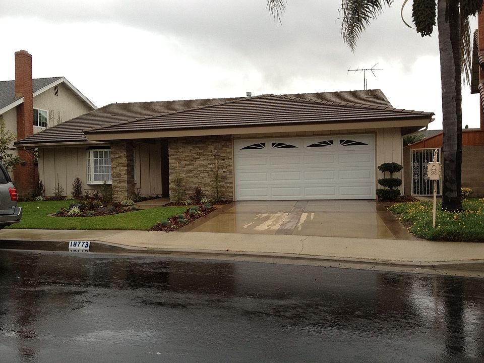 Front with new concrete, stacked stone entry and new landscaping
