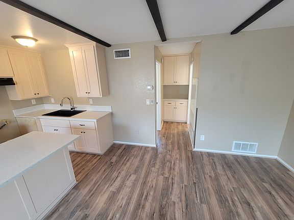 Hallway with cabinet. Left Bedroom, Right Bathroom.