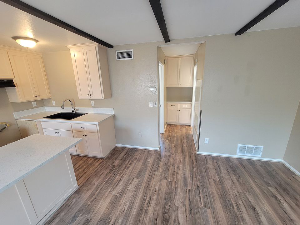 Hallway with cabinet. Left Bedroom, Right Bathroom.