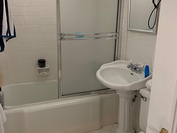 Smaller full bath off front bedroom.