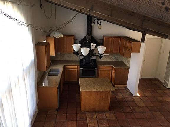 Photo from stairway. Open kitchen/living area. Bathroom downstairs.