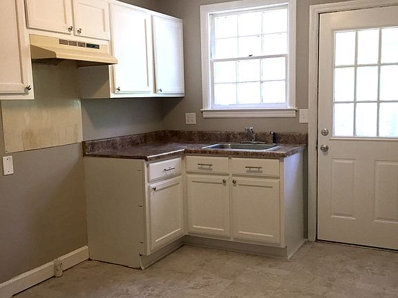 Eat-in kitchen has freshly painted walls and cabinets with n