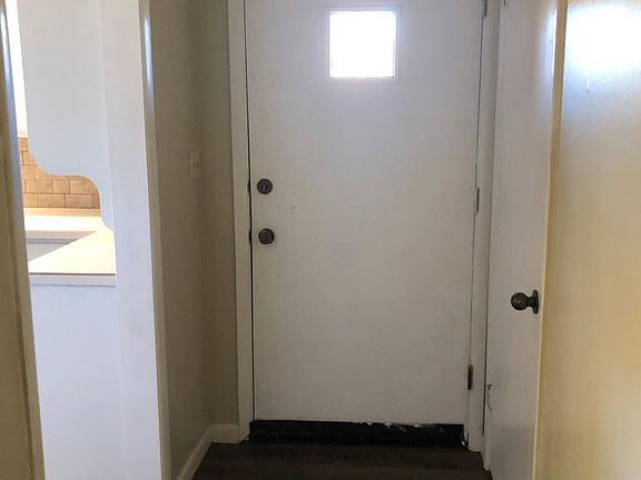 Hallway looking toward front door. Coat closet to the right, Kitchen to the left.