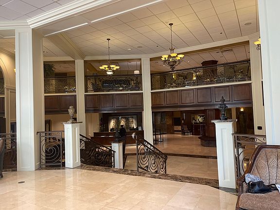 Main two story lobby with 24/7 concierge desk to the left of center between the columns