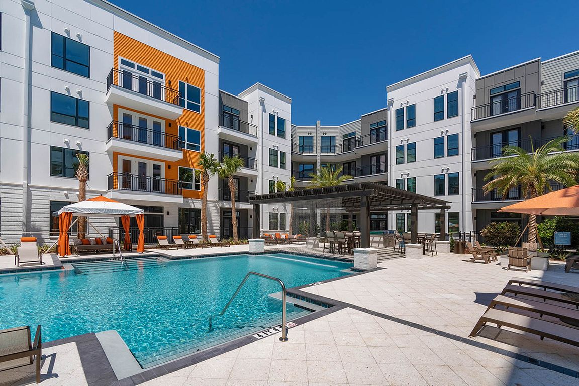 Enjoy the sun by the pool in this luxurious apartment community.