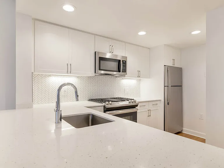 Kitchen with Gas Stove, Stainless Steel Appliances and Quartz Countertops