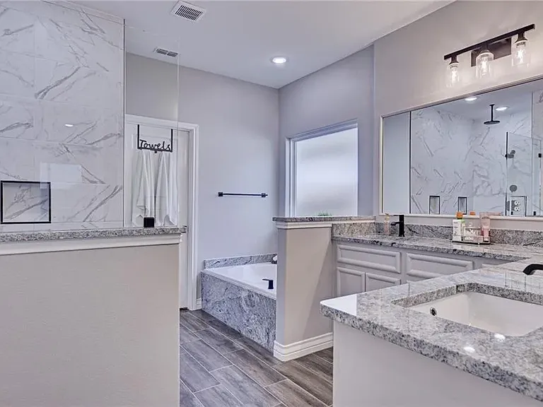Primary bathroom featuring a deep soaking tub-perfect for relaxing and unwinding.