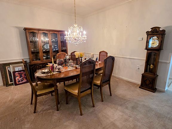 Elegant formal dining room featuring classic wainscoting and a statement chandelier_perfect for hosting and memorable dinners.