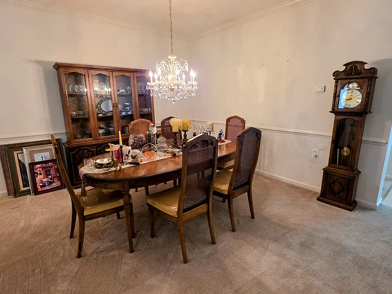 Elegant formal dining room featuring classic wainscoting and a statement chandelier_perfect for hosting and memorable dinners.