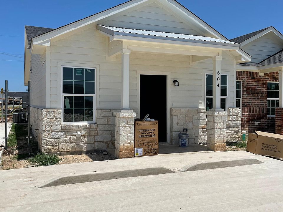 Exterior shows two parking spots