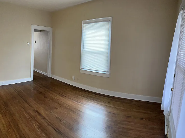 Living room, view 2 - Doorway leads to the kitchen and staircase to 2nd floor.