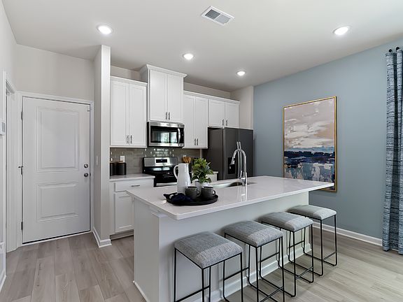 A large kitchen island overlooks the sprawling great room, perfect for entertaining.
