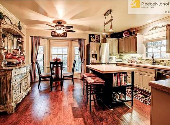 Updated Kitche, freahly painted cabinets, newer wood floors and Island Bar
