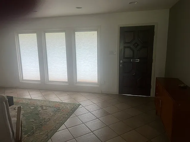 Living room with front door entrance.