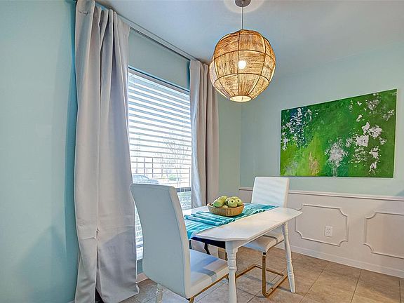 Breakfast room has basket light fixture and plenty of natural light.