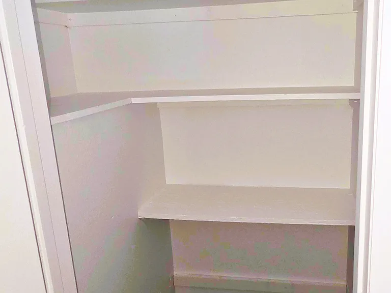 Spacious storage closet with built-in shelves for added organization.