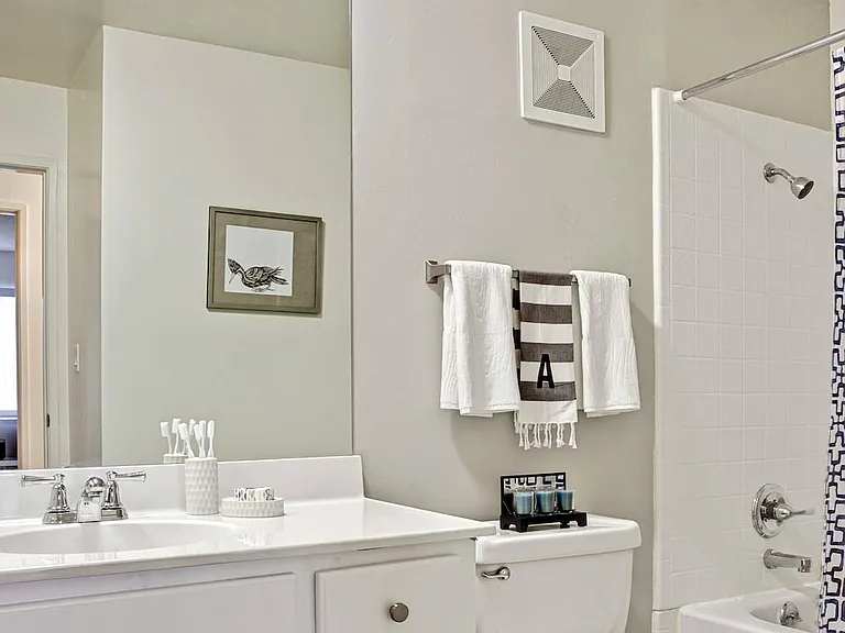 Classic Package I bath with white laminate countertop, white cabinetry, and hard surface flooring
