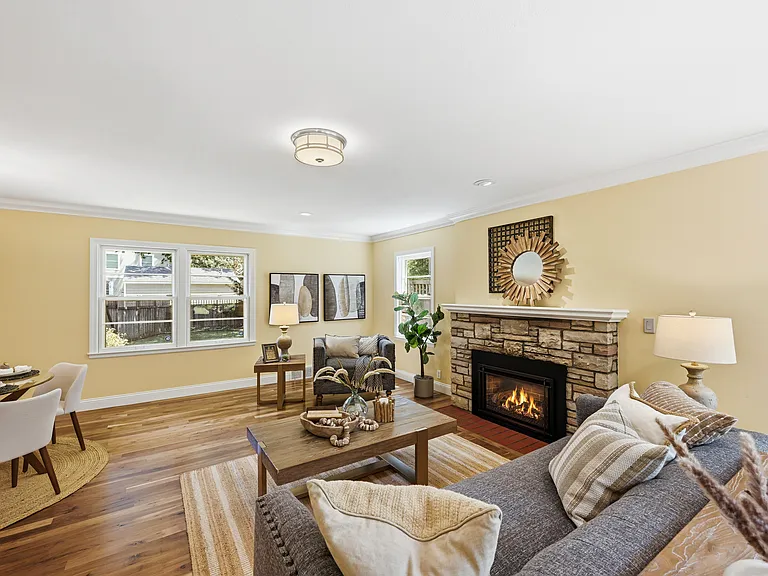 Living room with gas fireplace, open to dining area and kitchen