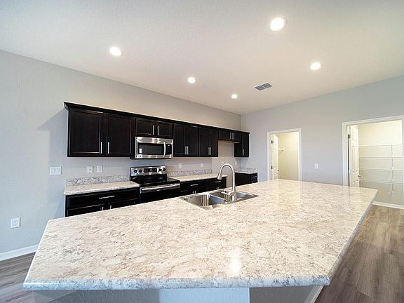 Open kitchen with Samsung SS appliances not pictured - New home for sale in Lake Alfred. Photo sho