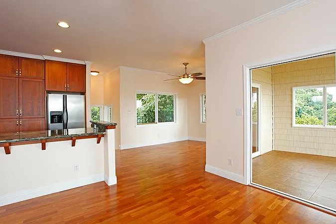 View from living room towards kitchen, dining, main entrance and lanai patio
