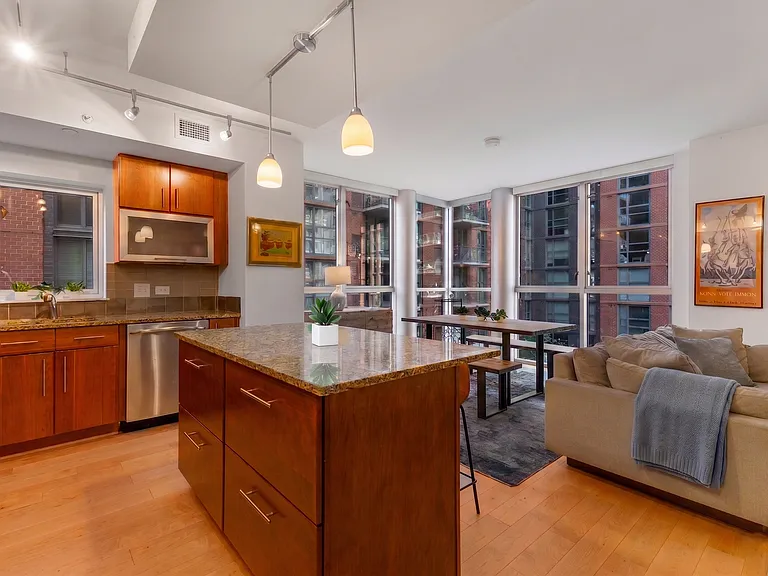 The open-concept layout seamlessly connects the chefs kitchen to the bright dining and living area.