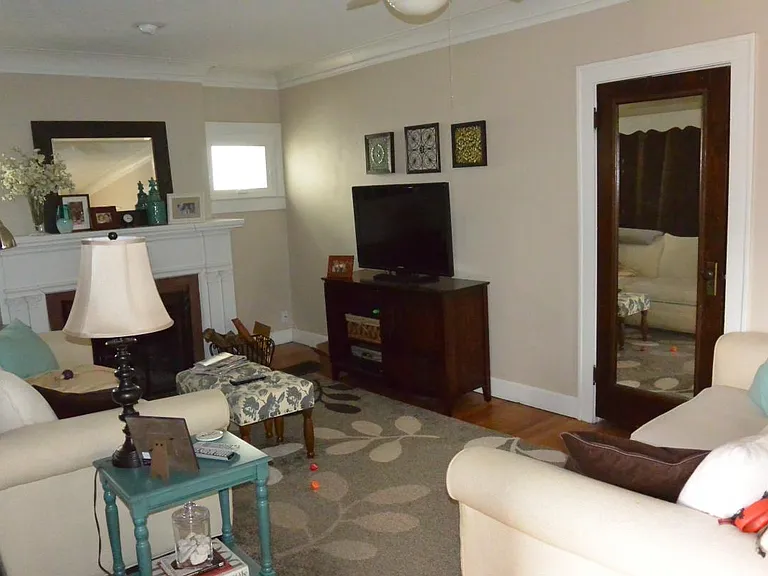 Living room with mirror on large closet.