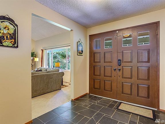 Enter through double doors to the slate tiled entry.