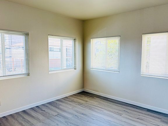Living room opposite wall with corner windows.