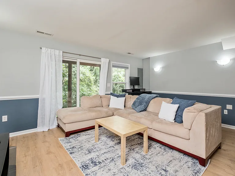 Bonus room in the walk out basement with sit to stand desk and large television.