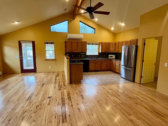 Beautiful light and bright living room. The mini-split is on the far wall. The sunroom entry is the wall to the right, and the laundry and garage is to the right.