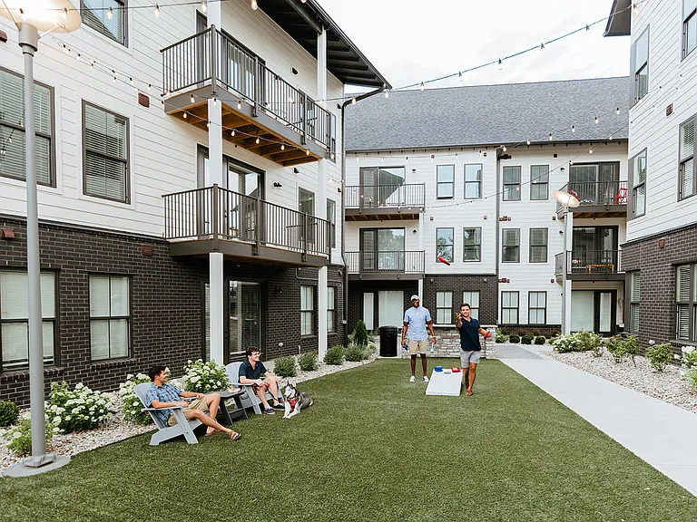 Outdoor courtyard with cornhole