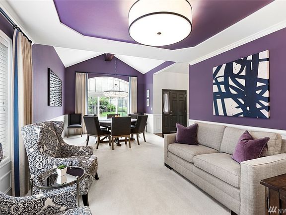 Coved ceiling living room looking into vaulted dining room.