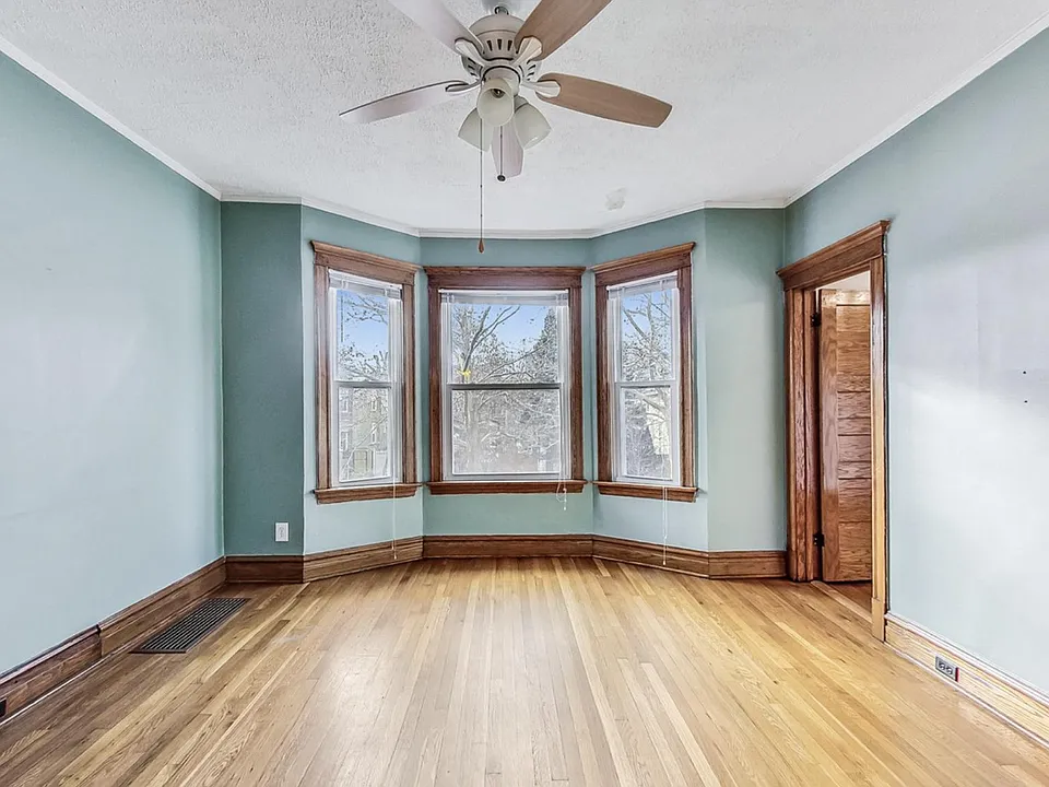 Main living room gets amazing natural light. Door on the right is to a bedroom