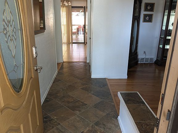 Entrance in to house, looking all the way through to the sliding back doors.